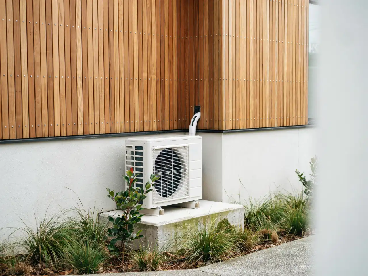 Heat pump outdoor unit on a Tauranga home